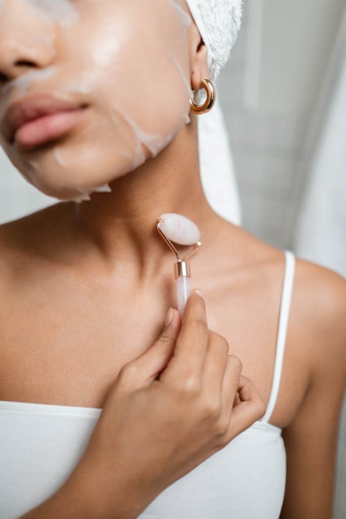 Crop Photo Of Woman Using A Facial Roller